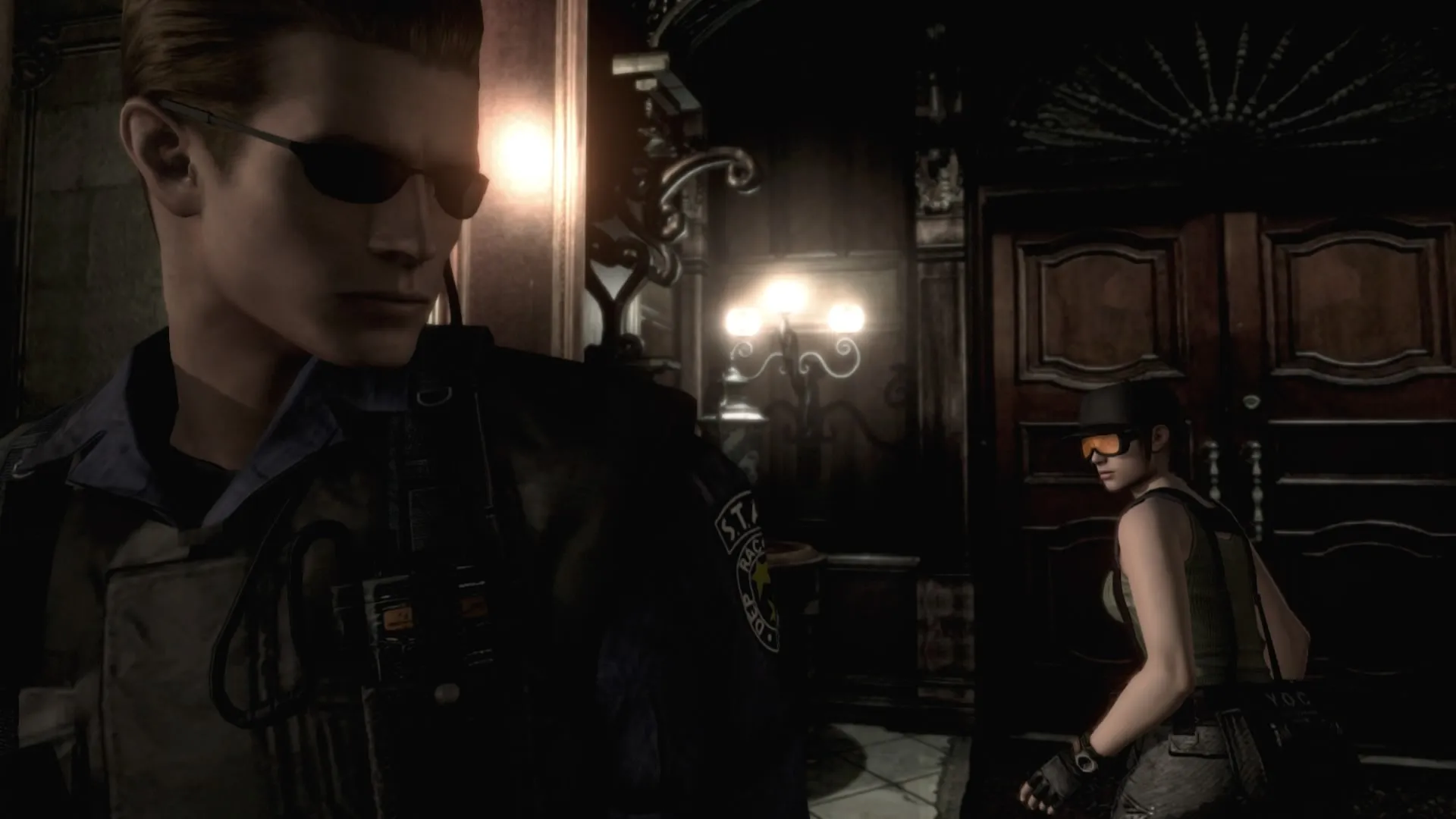 Wesker y Jill en el hall de la mansión